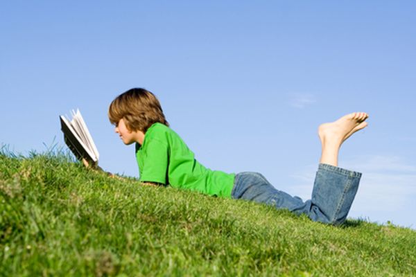 child reading book outdoors