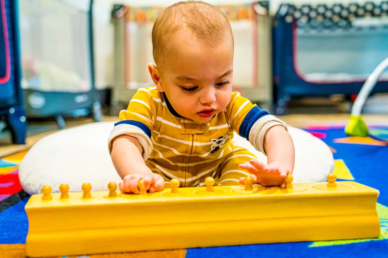 toddler playing with montessori materials