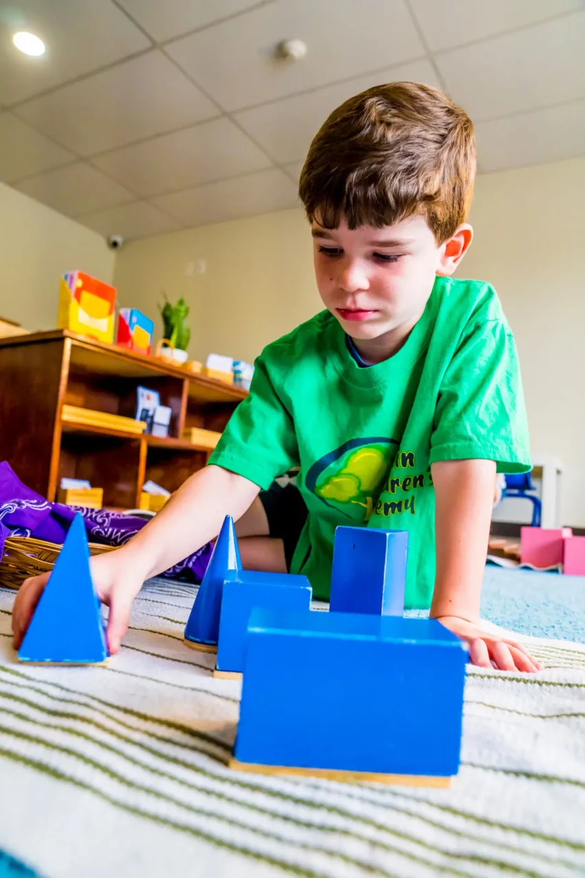 child playing with montessori materials