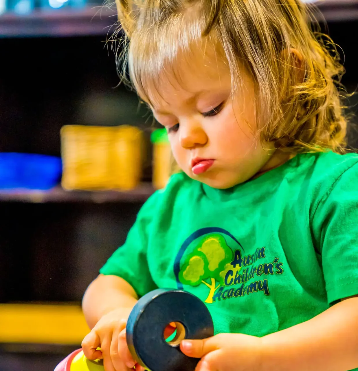 child on playing with montessori materials