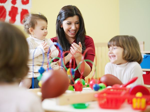 female toddler and 2-3 years girls playing with toys in kindergarten. Horizontal shape